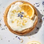 Lemon cookie topped with frosting and lemon.